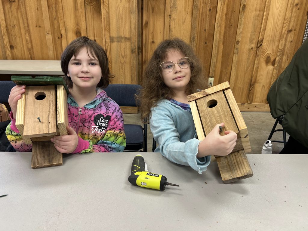 two kids with birdhouses